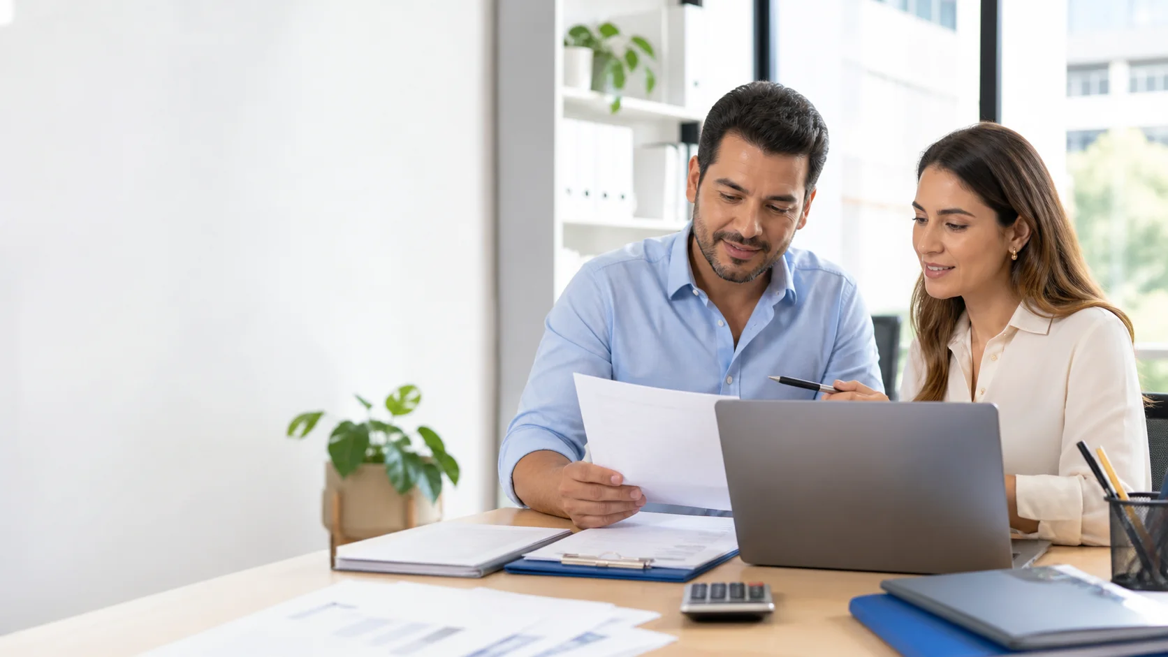 Empresario y contadora revisando información financiera en una oficina